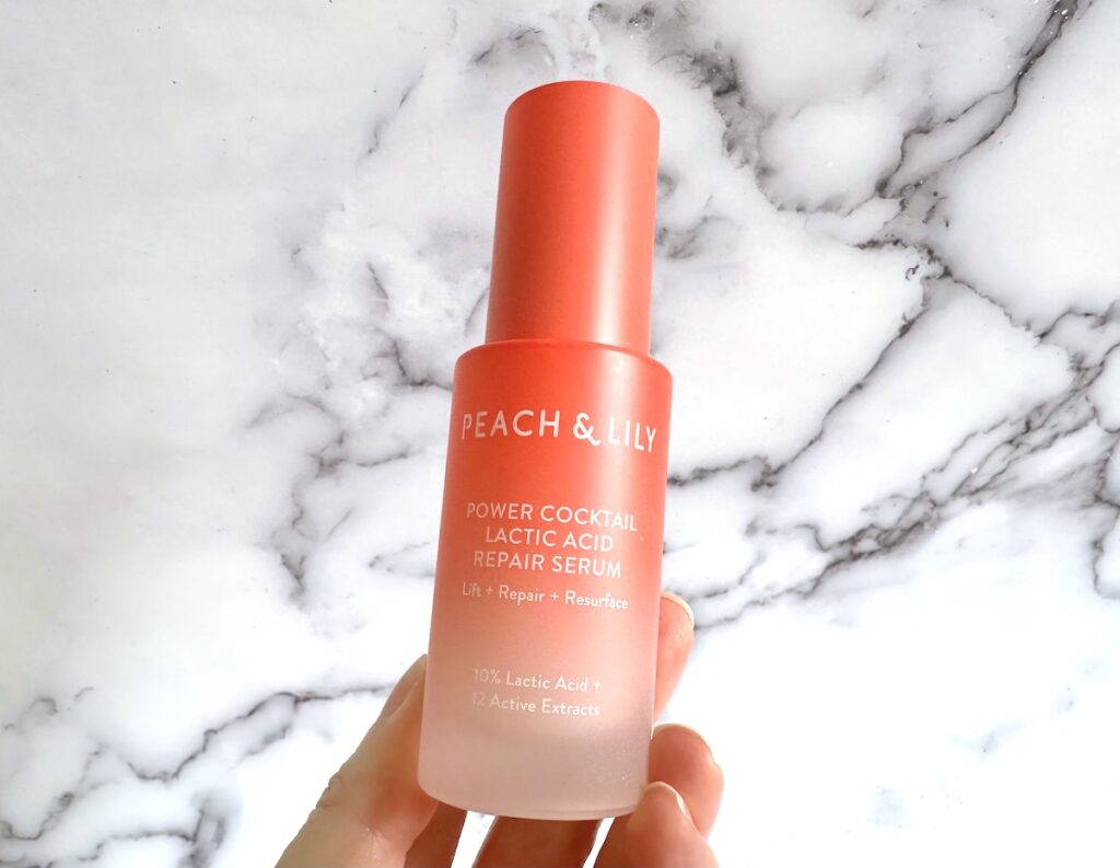 Peach & Lily Power Cocktail Lactic Acid Repair Serum, handheld.