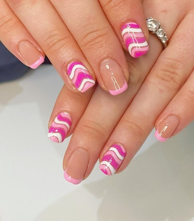 Pink and white swirl nails.