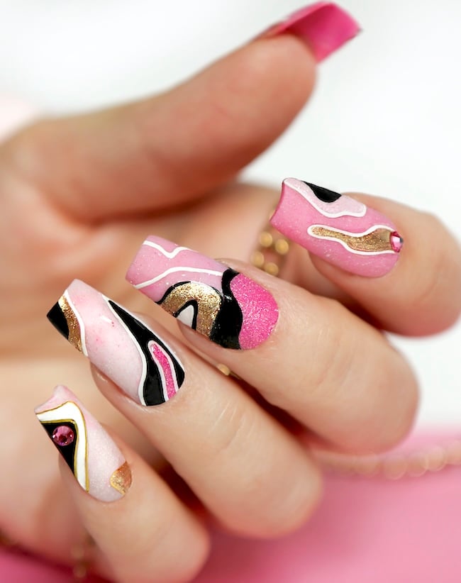 Pink and black swirl nails.