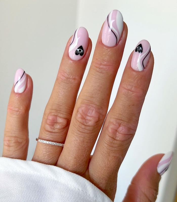 Pink and black Valentine's heart nails.