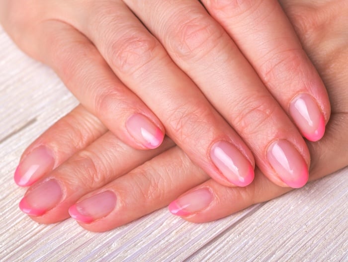 Pink French tip nails.