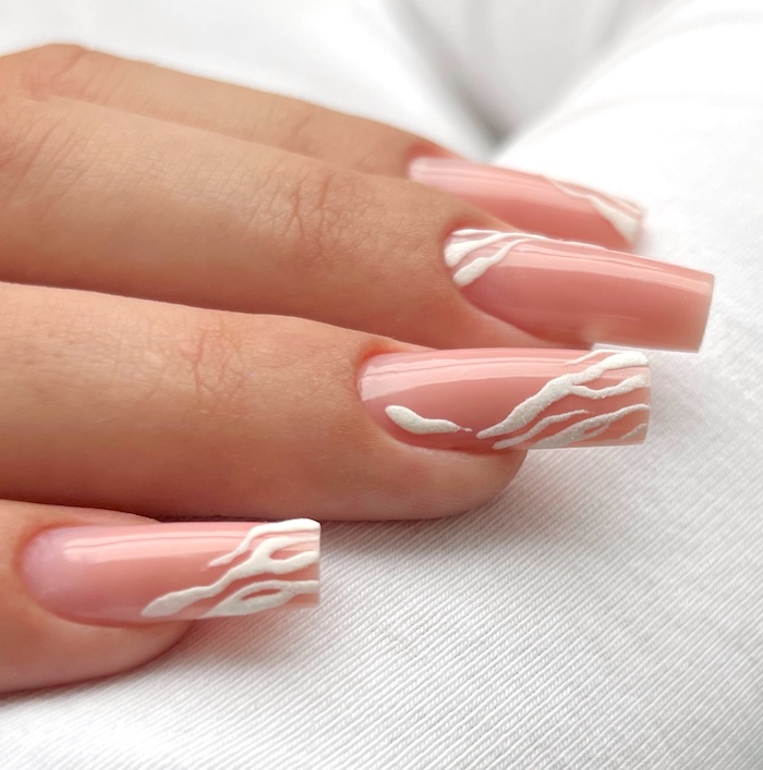 Coral pink and white waves on long square nails.