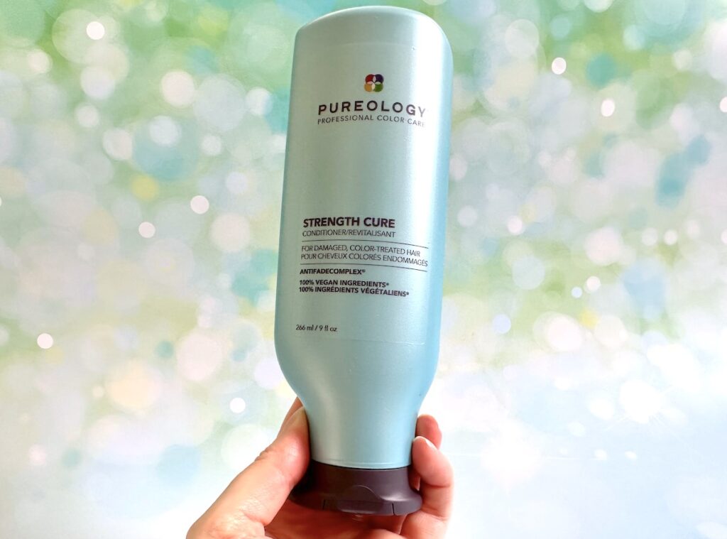 Pureology Strength Cure Conditioner, handheld.