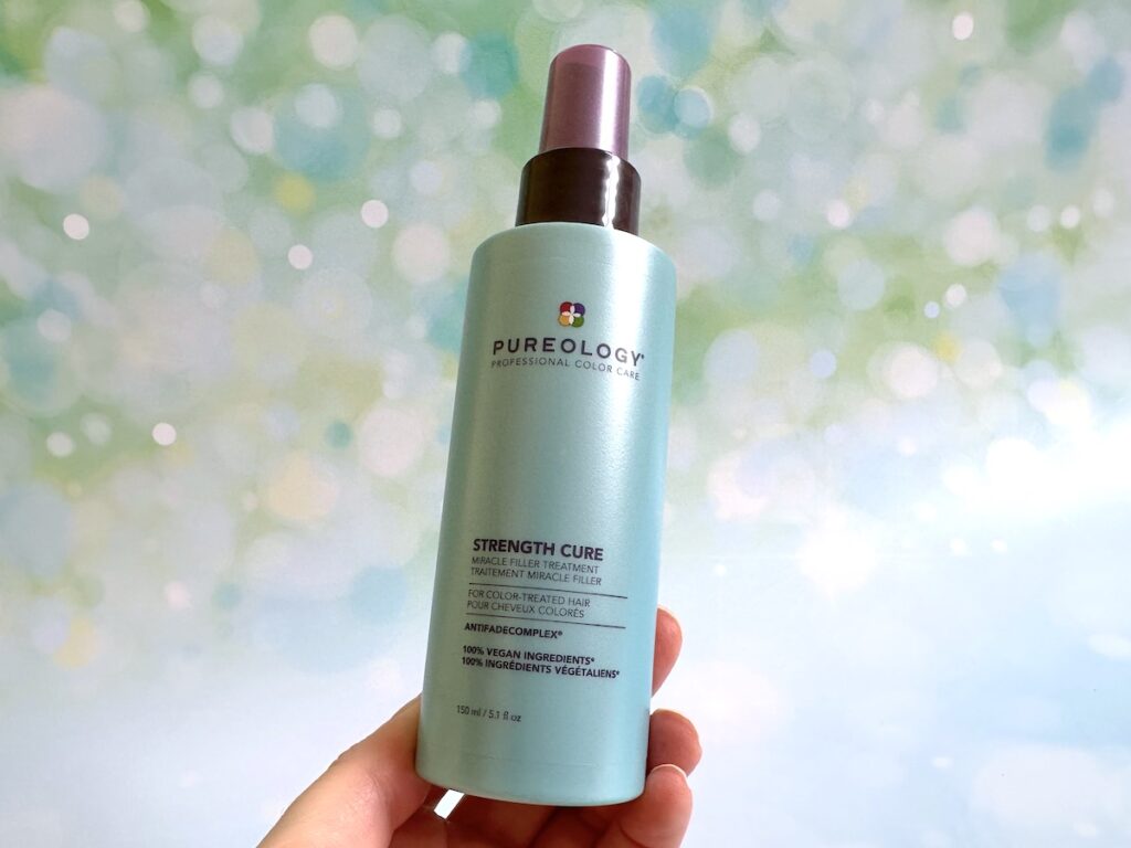 Pureology Strength Cure Miracle Filler Leave-In Conditioner, handheld.