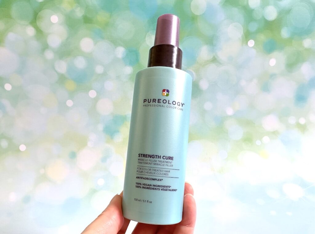 Pureology Strength Cure Miracle Filler Leave-In Conditioner, handheld.