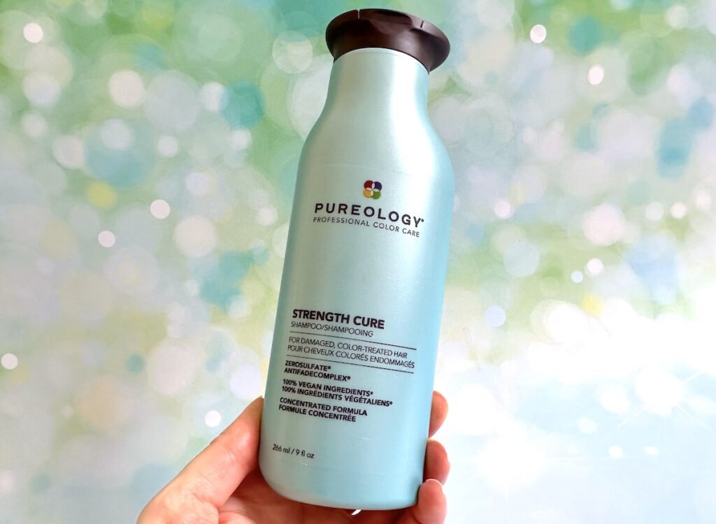 Pureology Strength Cure Shampoo, handheld.