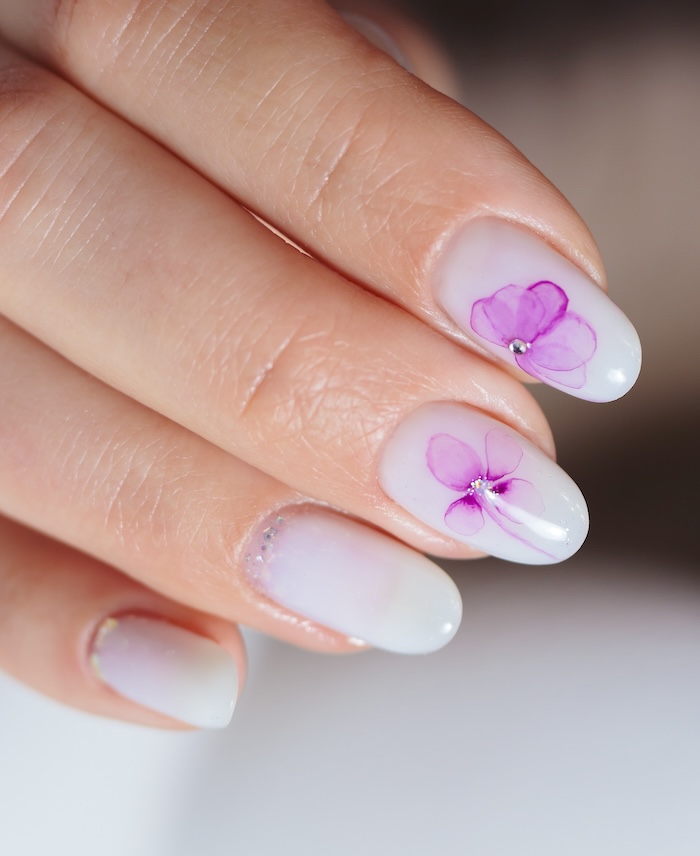 Lavender purple flower rhinestone nails.