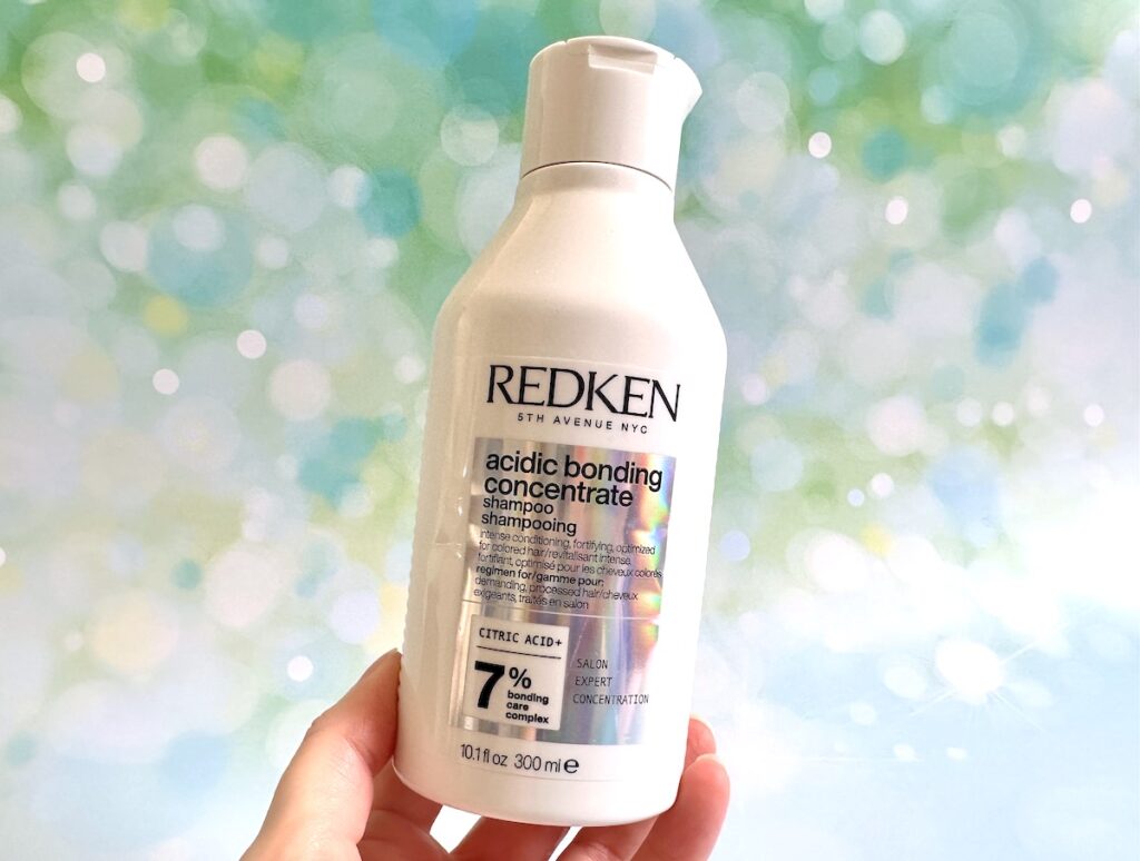 Redken Acidic Bonding Concentrate Shampoo, handheld.