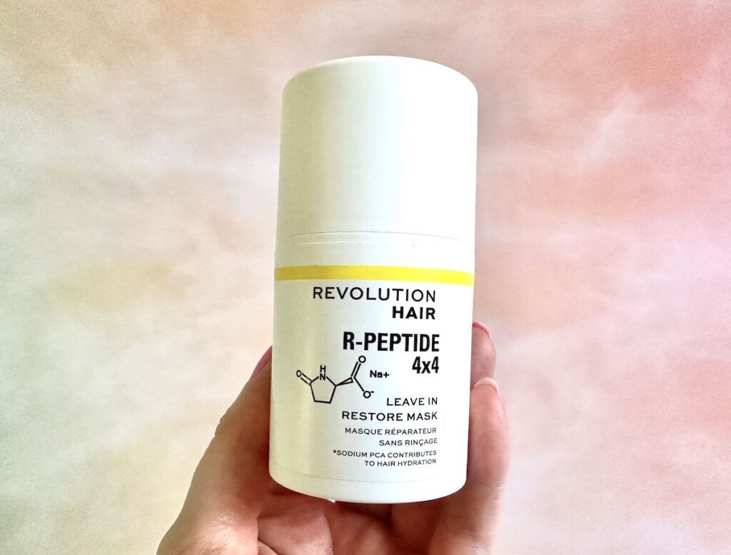 Revolution Haircare R-Peptide 4x4 Leave-In Repair Mask, handheld.