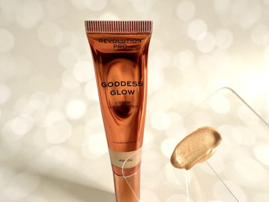 Revolution Beauty Revolution Pro Goddess Glow Cream Highlighter in the shade Aglow and highlighter sample on clear plastic spatula.