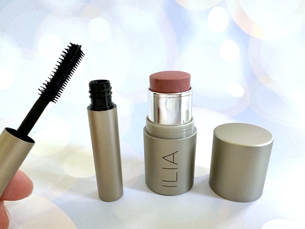 Ilia Makeup Birthday Gift Set: Ilia Limitless Lash Mascara, open with wand handheld, and Ilia Multi-Stick in the shade At Last.