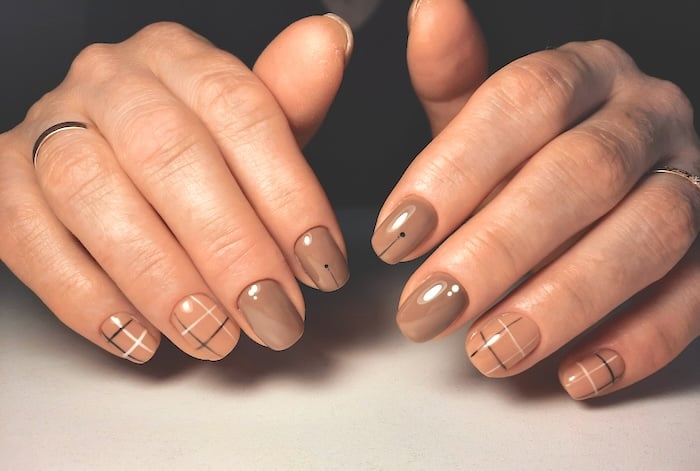 Short taupe nails with lines.