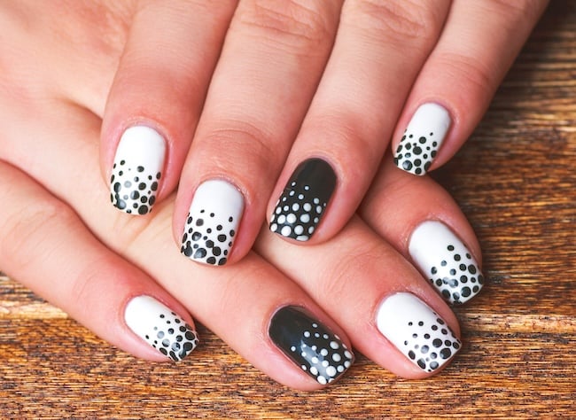 White and black polka-dot short nails.