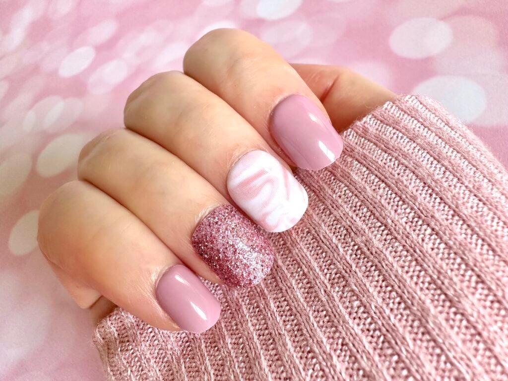 Pink and White Nails on pink sweater sleeve.