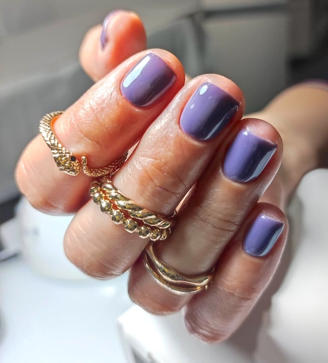 Short purple nails.