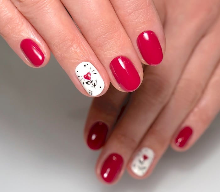 Short red and white heart nails.