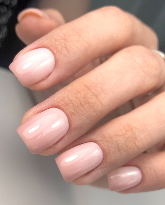 Soft pink ombre nails on short square nails.