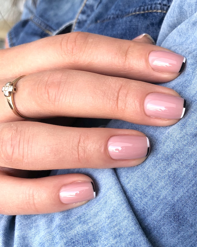 Short white and black French tip nude pink nails.