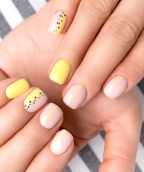 Short yellow and white nails.