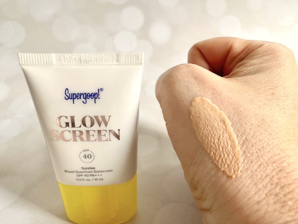 Supergoop! Glowscreen Sunscreen SPF 40, tube next to sample on hand.