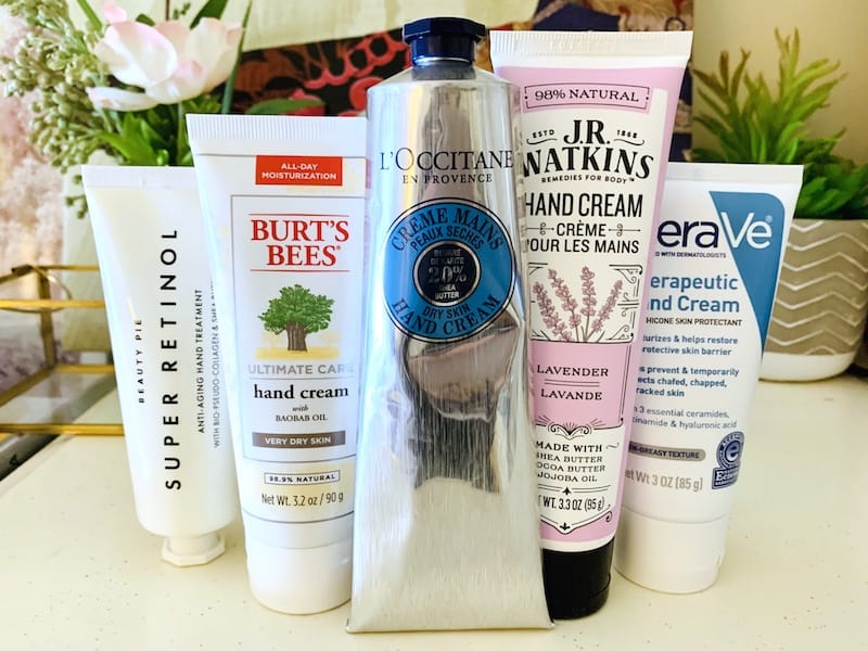 Drugstore and Luxury Hand Creams for Dry Skin in front of Flowers