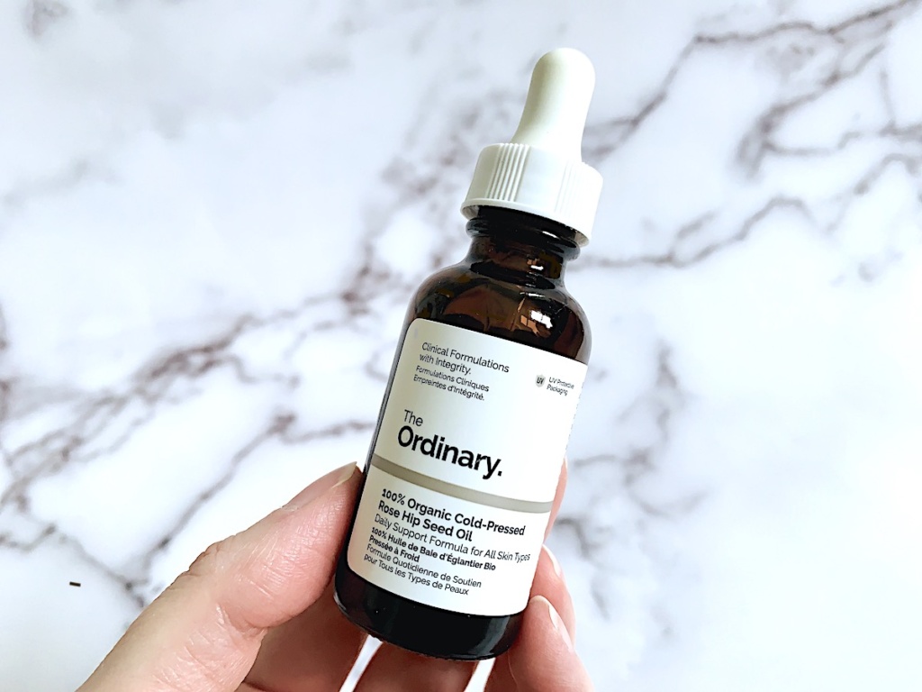 Hand holding The Ordinary 100% Organic Cold-Pressed Rose Hip Seed Oil