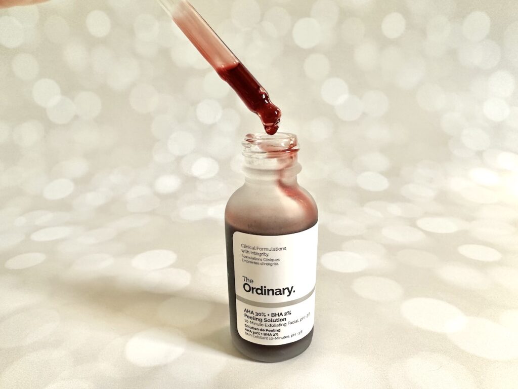 The Ordinary AHA 30% + BHA 2% Peeling Solution, open bottle with dropper applicator showing red serum.