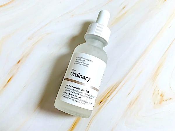 The Ordinary Alpha Arbutin 2% Serum + HA flatlay.