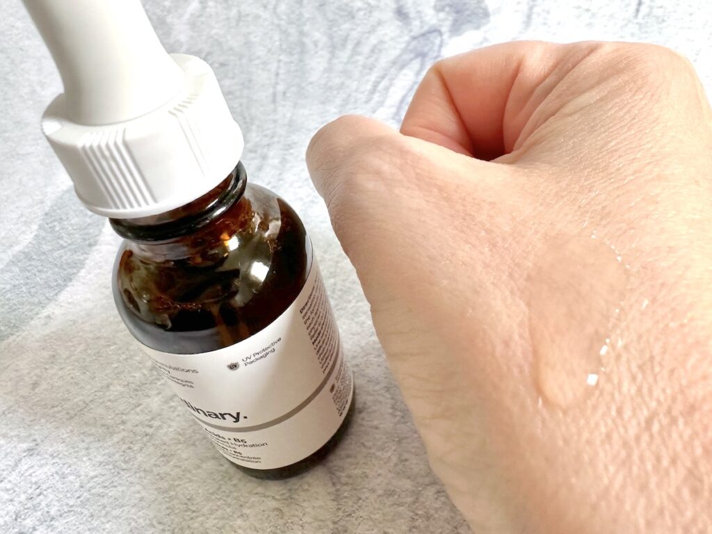 The Ordinary Amino Acids + B5 bottle next to sample on hand.