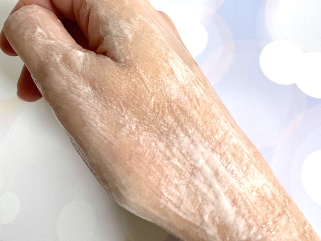 The Ordinary Glycolipid Cream Cleanser flatlay next to sample on hand mixed with water.