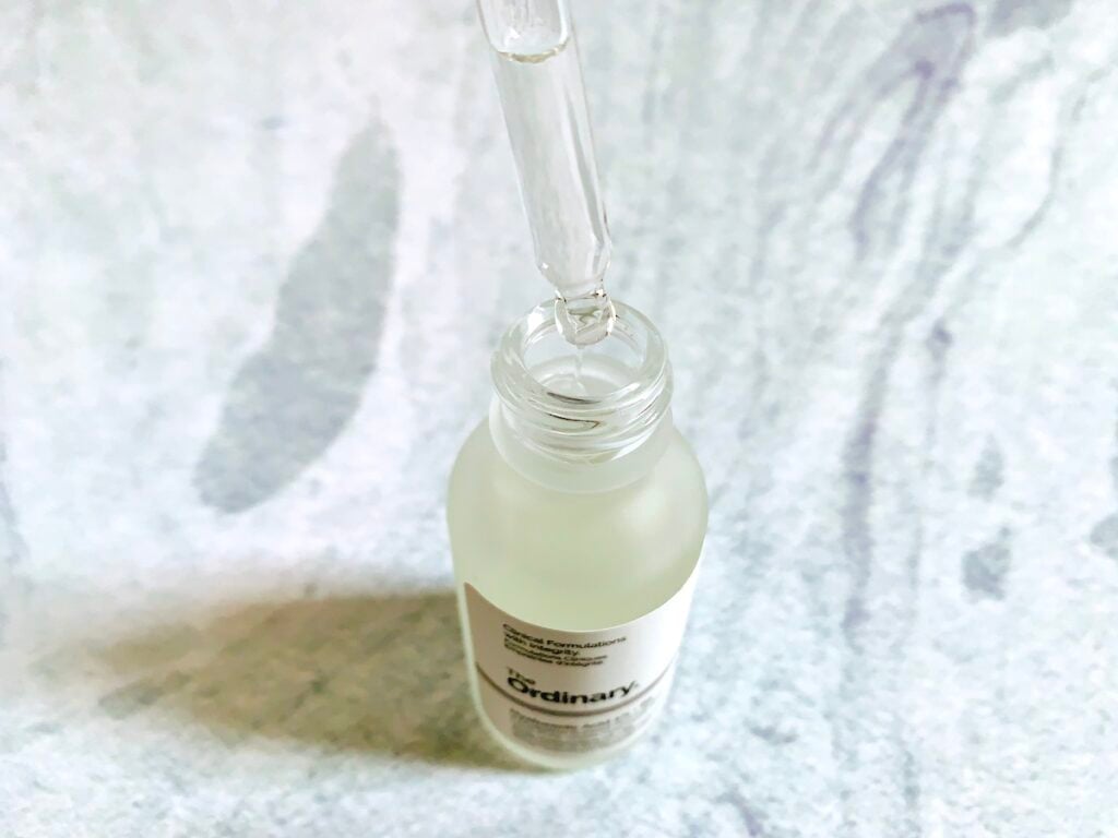 The Ordinary Hyaluronic Acid 2% + B5 Serum opened with dropper on a pale blue background.