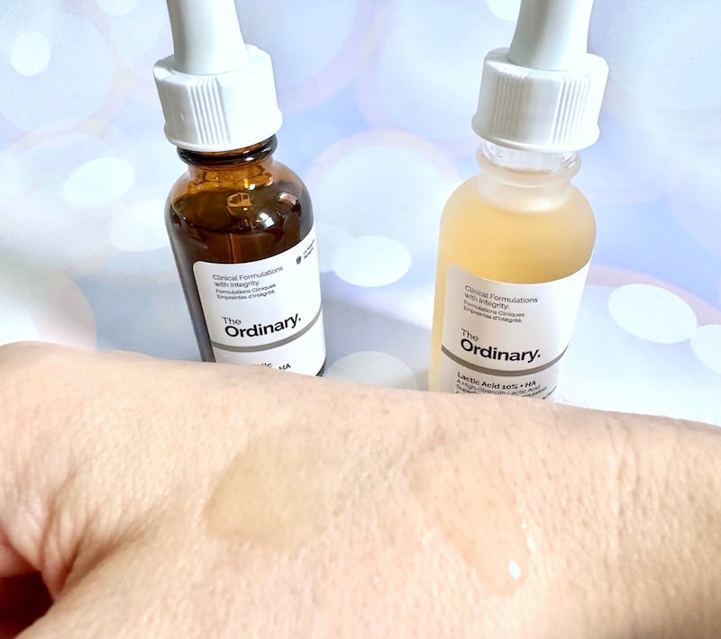 The Ordinary Mandelic Acid 10% + HA and The Ordinary Lactic Acid 10% + HA, bottles next to samples on hand.