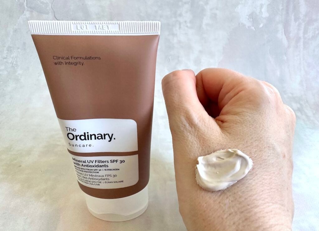 The Ordinary Mineral UV Filters SPF 30 with Antioxidants tube next to sample on hand.