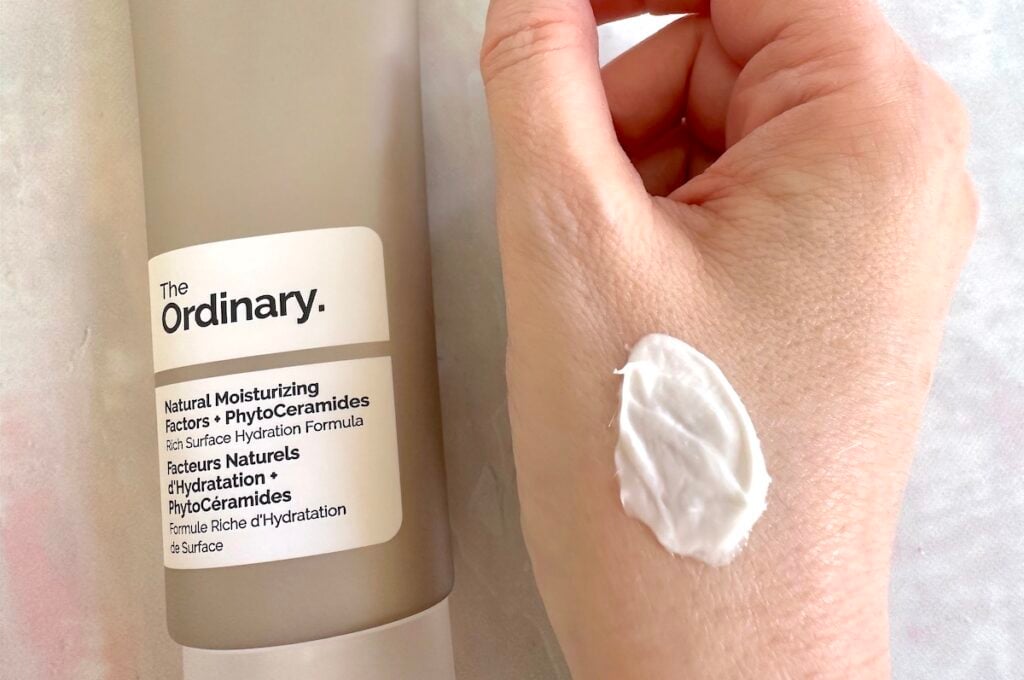 The Ordinary Natural Moisturizing Factors + PhytoCeramides, flatlay and sampled on hand.