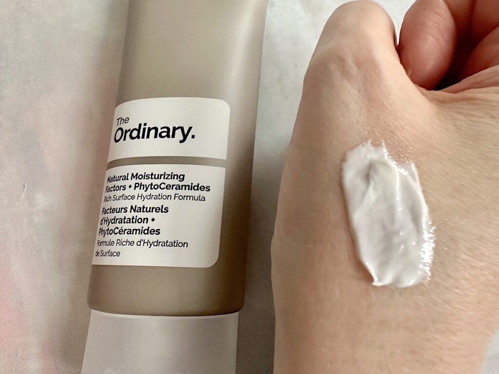 The Ordinary Natural Moisturizing Factors + PhytoCeramides, flatlay and sampled on hand.