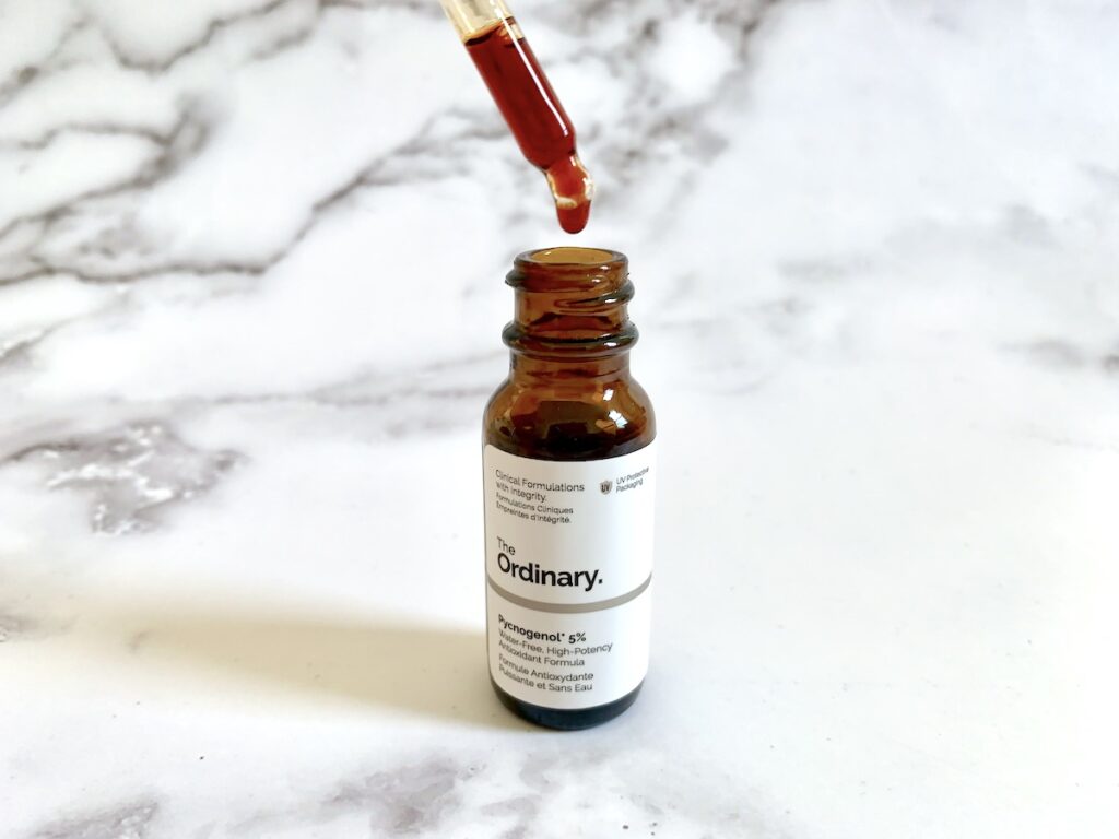 The Ordinary Pycnogenol 5% antioxidant serum open with dropper showing red color.