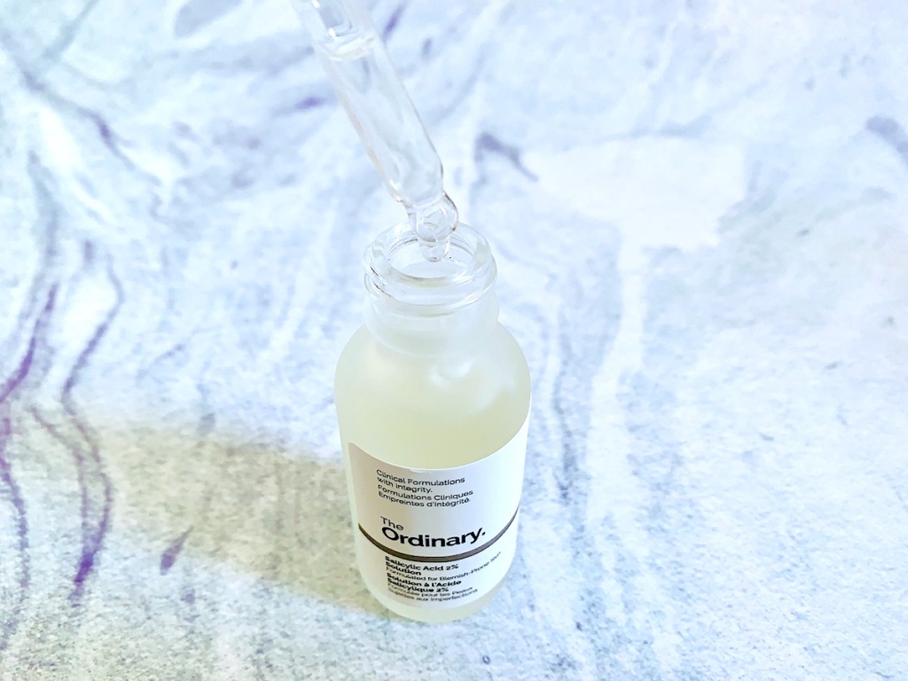 The Ordinary Salicylic Acid 2% Solution (Reformulated) opened with dropper on blue background