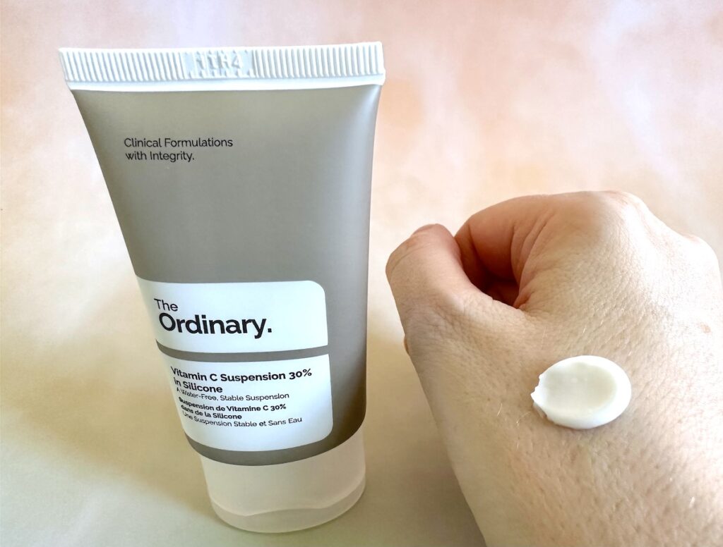 The Ordinary Vitamin C Suspension 30%, tube next to sample on hand.