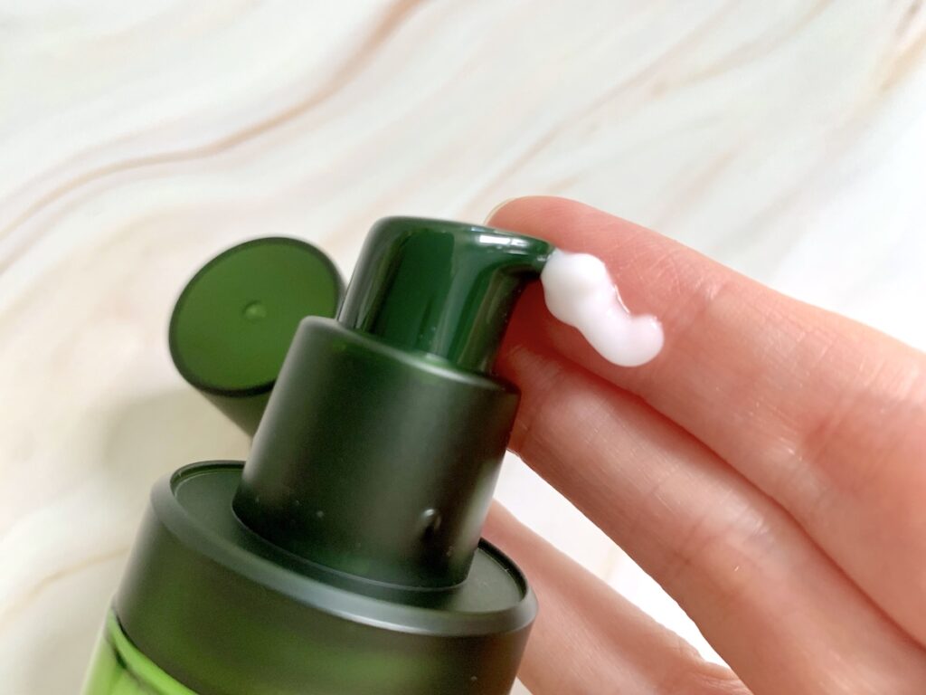 Tonymoly The Chok Chok Green Tea Watery Essence dispensed onto finger.