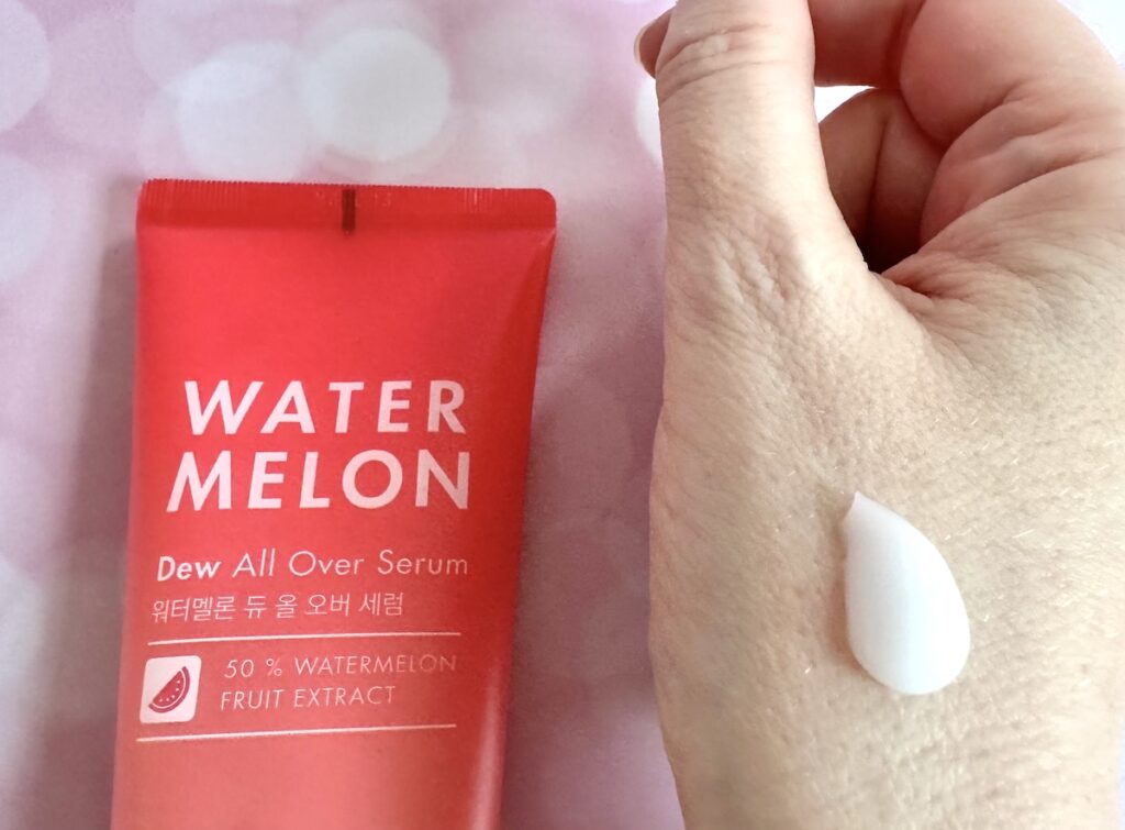 Tonymoly Watermelon Dew All Over Serum, flatlay next to sample on hand.