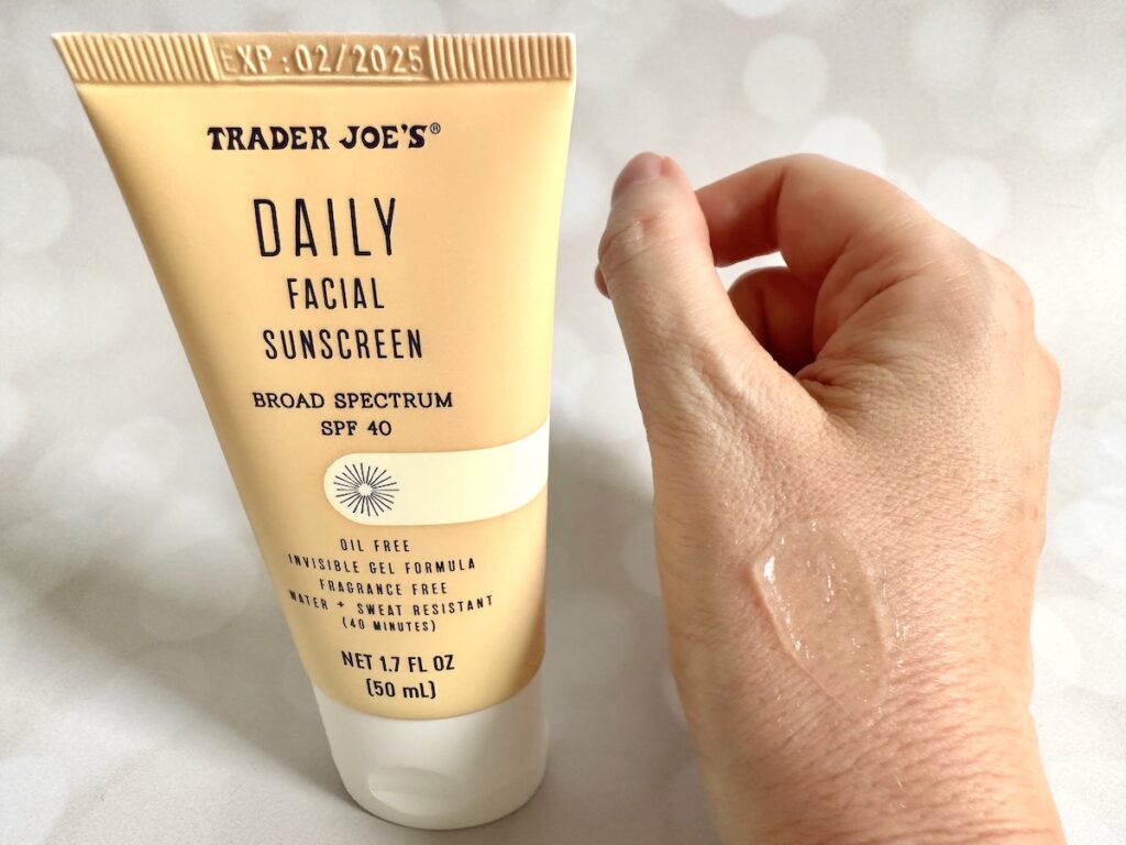 Trader Joe's Daily Facial Sunscreen Broad Spectrum SPF 40 tube next to sample on hand.