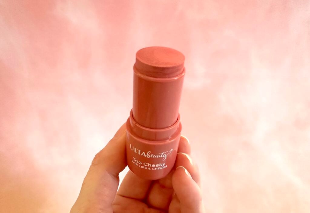 Ulta Beauty Too Cheeky Lip & Cheek Color Stick in the shade Charmed, handheld in lid removed.