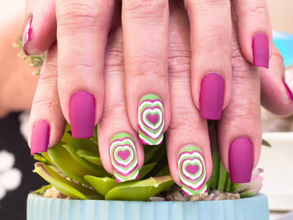 Purple and green heart nails for Valentines Day.