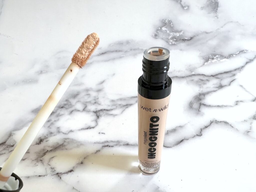 Wet n Wild Megalast Incognito All Day Full Coverage Concealer in the shade Light Beige, open tube with applicator.