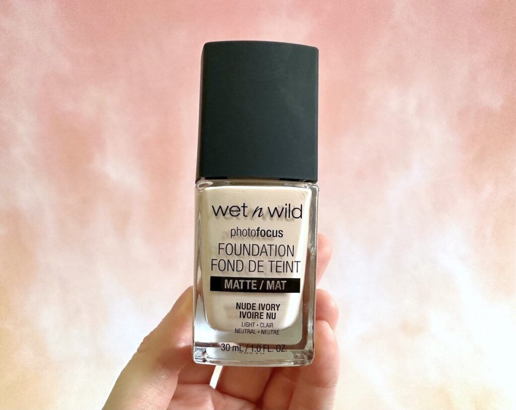 Wet N Wild Photofocus Matte Foundation in the shade Nude Ivory, handheld.