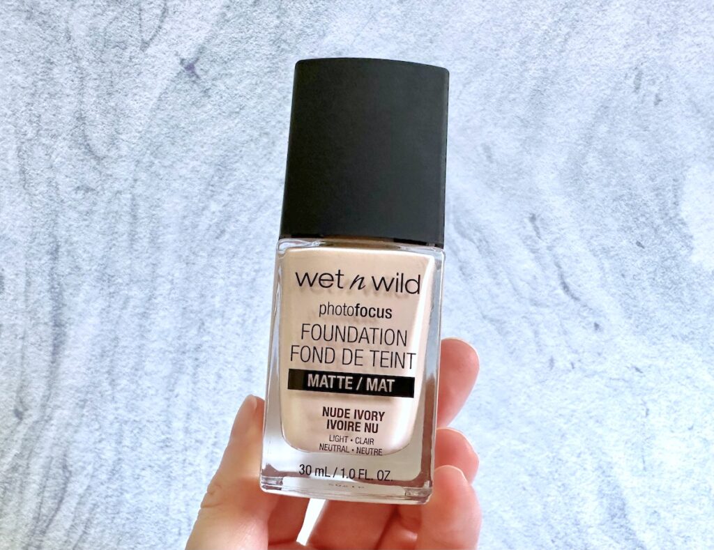 Wet N Wild Photofocus Matte Foundation in the shade Nude Ivory, handheld.