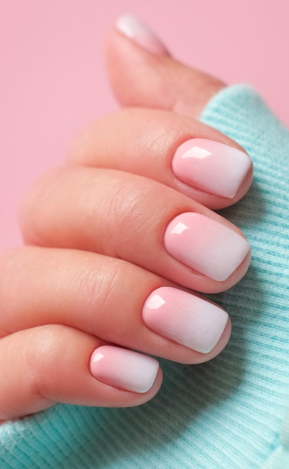 Pink and white ombre nails.