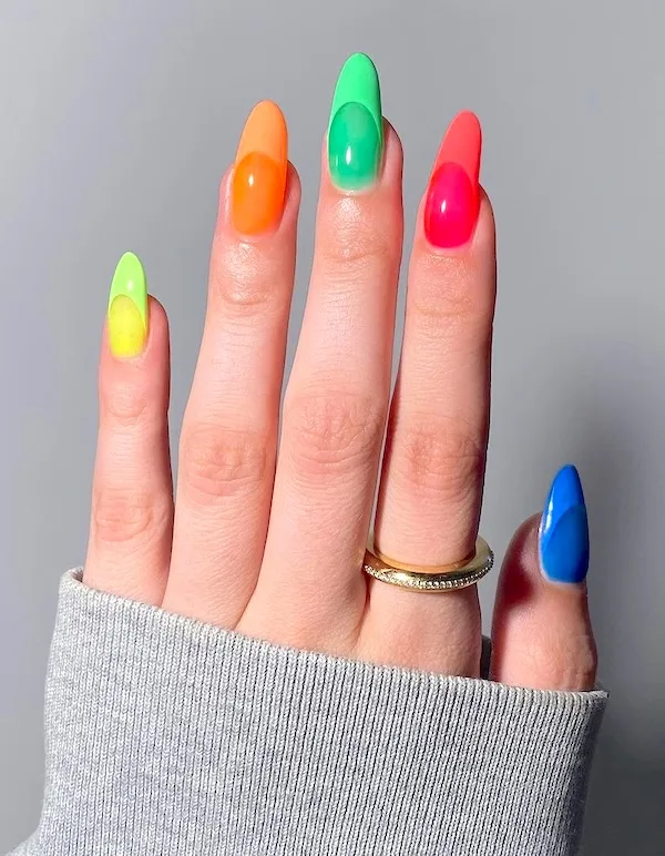 Rainbow almond nails with muted French tips.