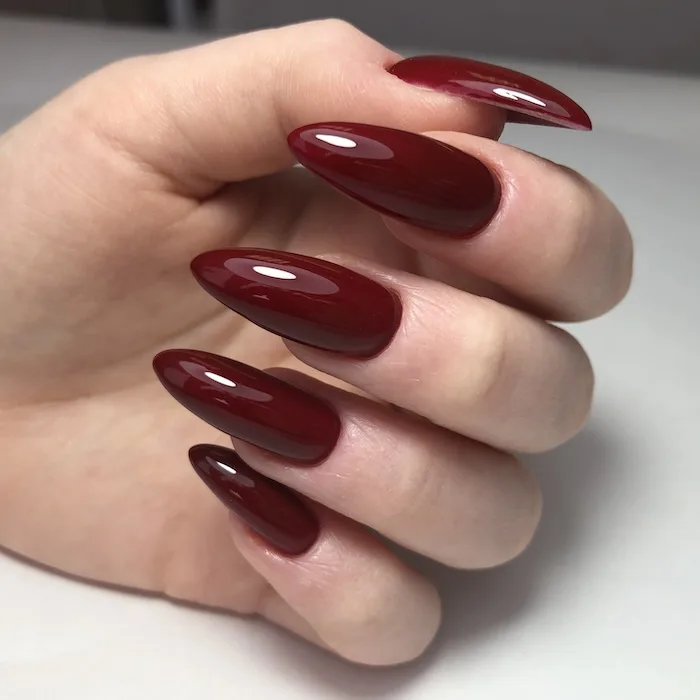 Dark red stiletto nails.