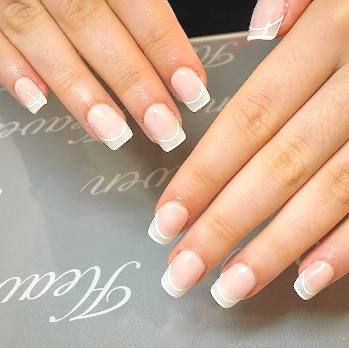 White outline French tip minimalist nails.